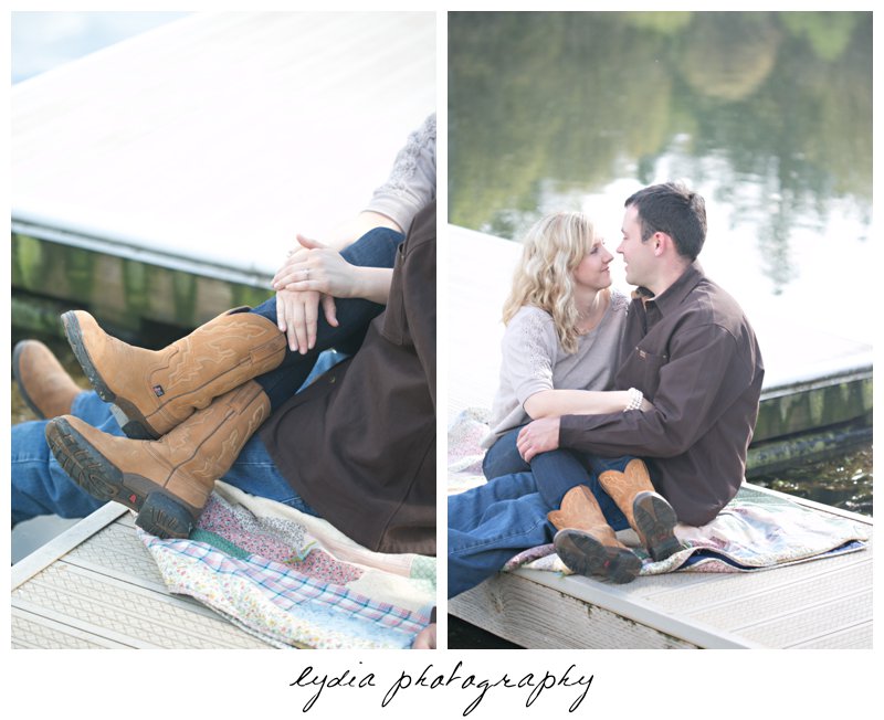 Bride and groom sitting on quilt at lifestyle engagement portraits at a lake in Grass Valley, California