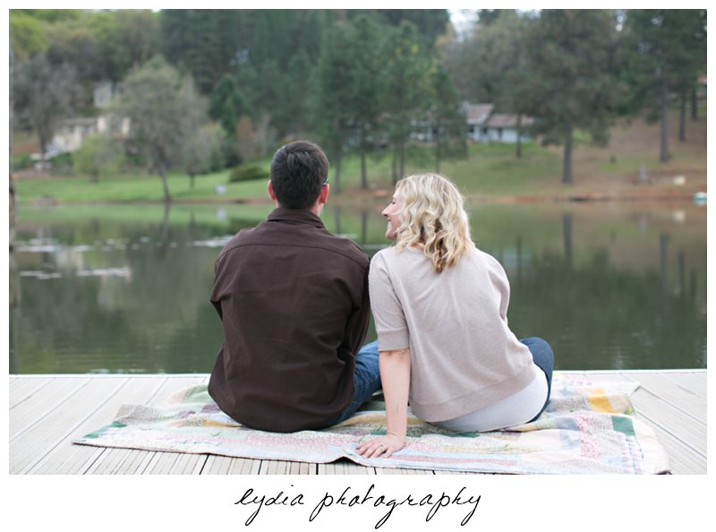 Bride and groom fishing at lifestyle engagement portraits at a lake in Grass Valley, California