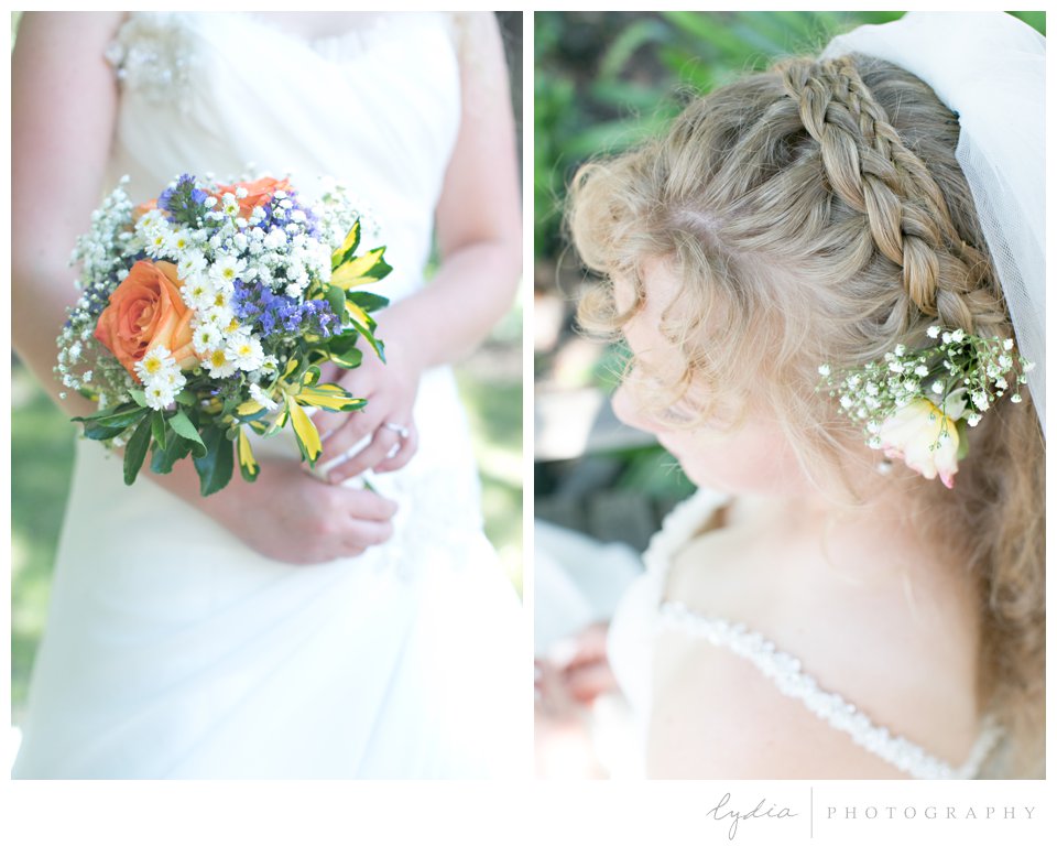 Bride holding coral and blue bouquet at