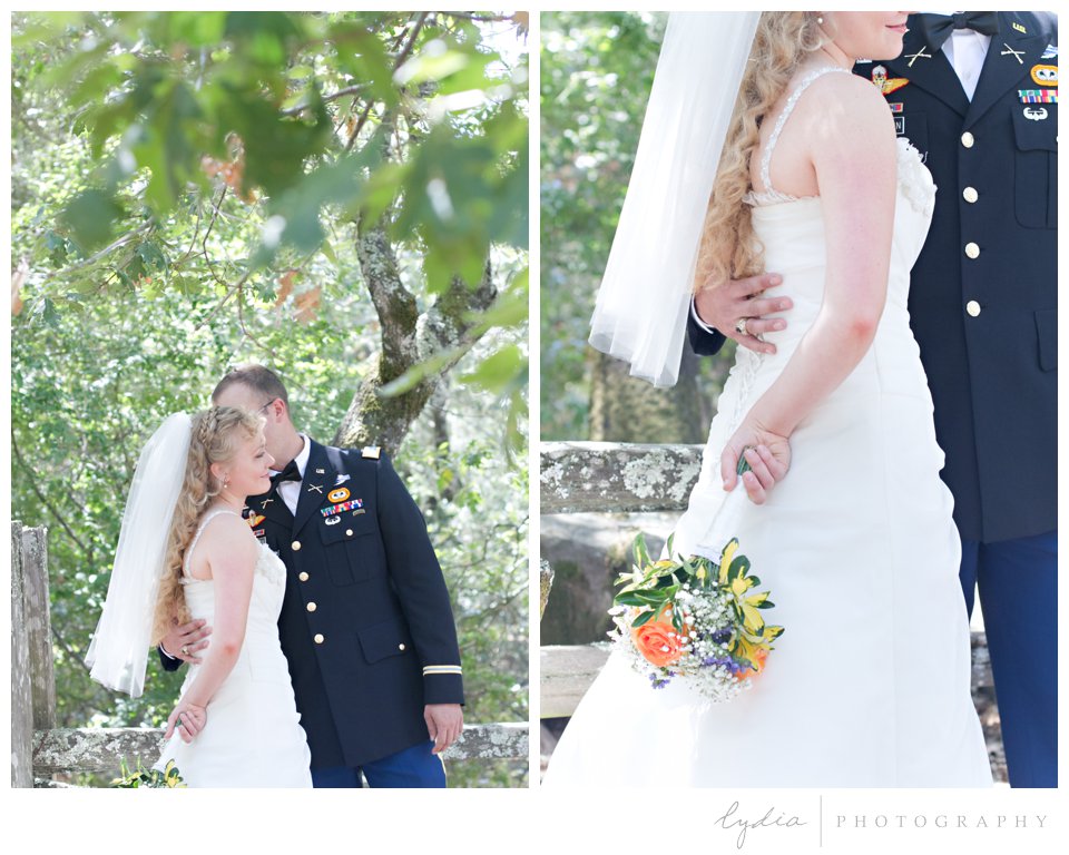 Groom in army dress blue kissing his bride at ethereal wedding in Santa Rosa, California