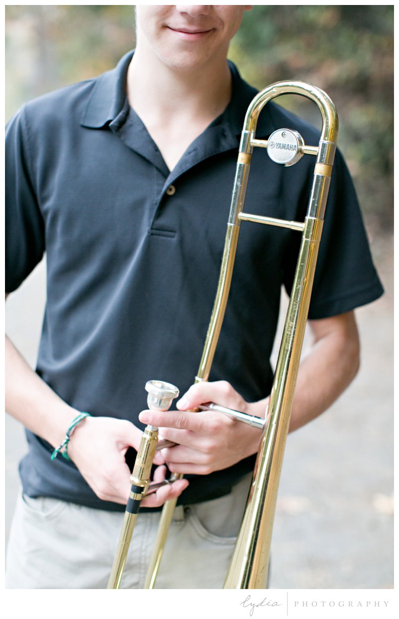 Senior guy's trombone for high school Ghidotti senior portraits at Little Deer Creek Trail in Nevada City, California