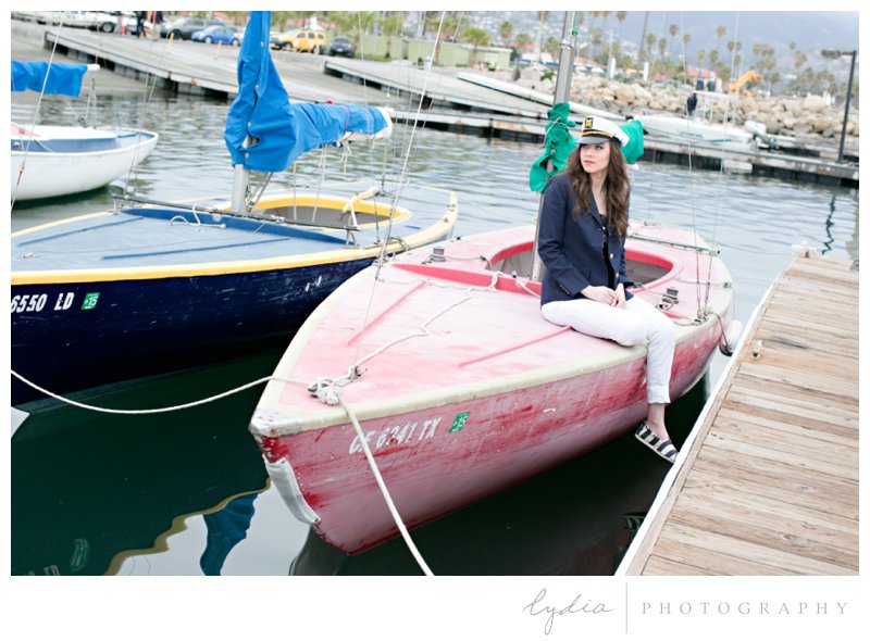 Senior sitting on a boat for a nautical senior styled inspiration portraits in Santa Barbara, California.
