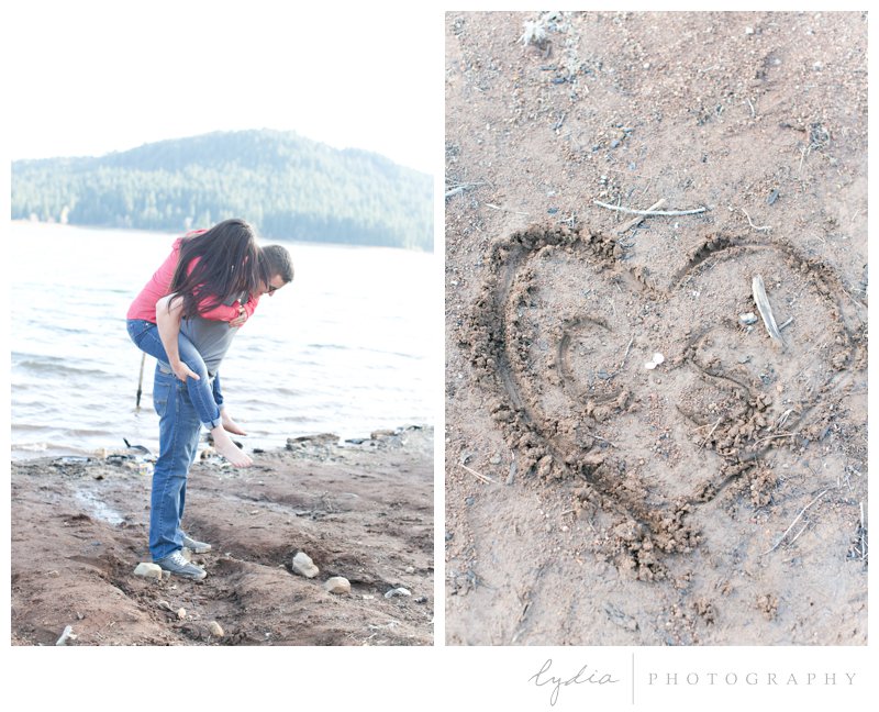 Bride having a piggyback ride and initials carved in a heart at a woodsy, nature engagement session at the Tahoe National Forest and at Scotts Flat Lake in Nevada City, California.