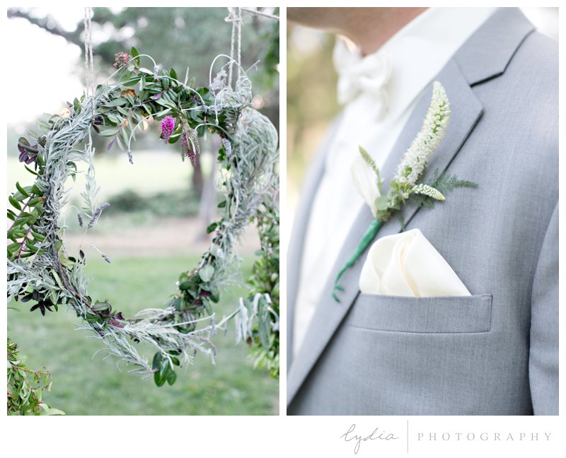Handing lavendar wreath backdrop and groomsman boutonniere at a southern garden wedding in Cottonwood, California.
