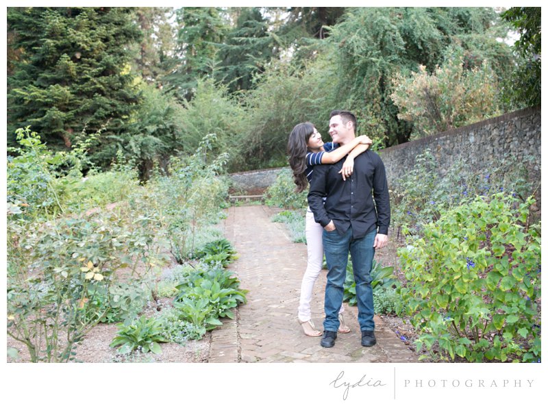 Bride and groom in rose garden at Empire Mine engagement portraits in Grass Valley, California.