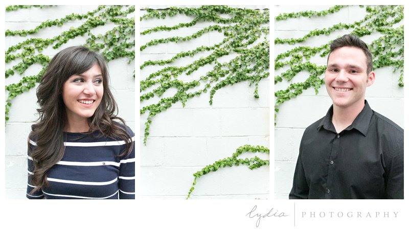 Bride and groom next to ivy wall at engagement portrait session in downtown Grass Valley, California.