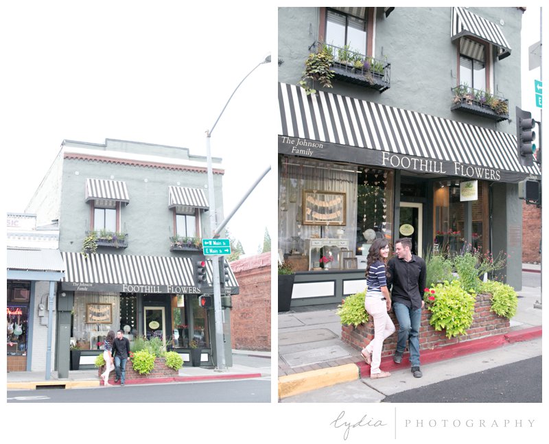 Bride and groom outside of flower shop at engagement portrait session in downtown Grass Valley, California.