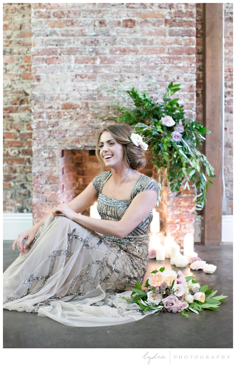 Bride in Adrianna Papell dress in front of fireplace at Old World Italy wedding.