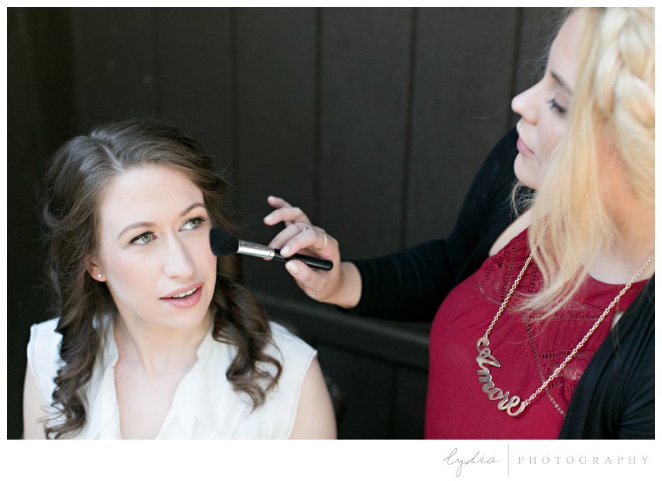 Bride having her makeup done at Harmony Ridge Lodge Jewish wedding in the Tahoe National Forest in California.