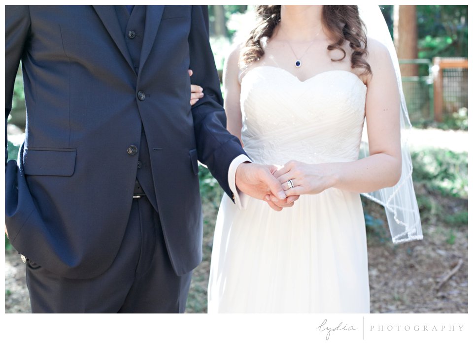 Bride and groom holding hands at Harmony Ridge Lodge Jewish wedding in the Tahoe National Forest in California.
