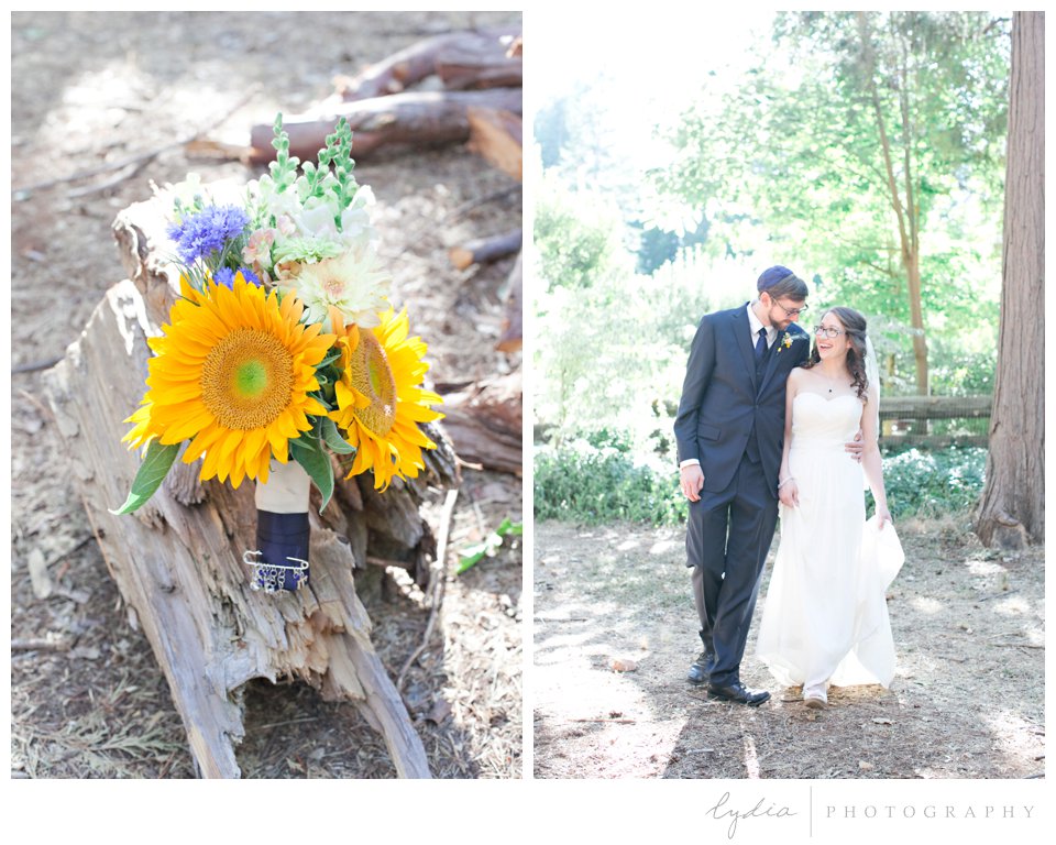 Sunflower bouquet and couple walking at Harmony Ridge Lodge Jewish wedding in the Tahoe National Forest in California.