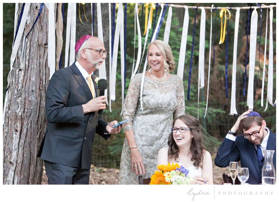 Father of the groom speaking at Harmony Ridge Lodge Jewish wedding in the Tahoe National Forest in California.