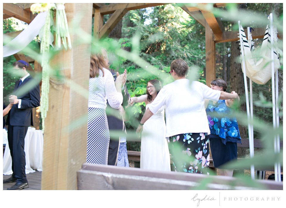 People dancing at Harmony Ridge Lodge Jewish wedding in the Tahoe National Forest in California.