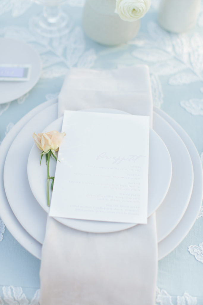 Elegant garden wedding reception with letterpress menu