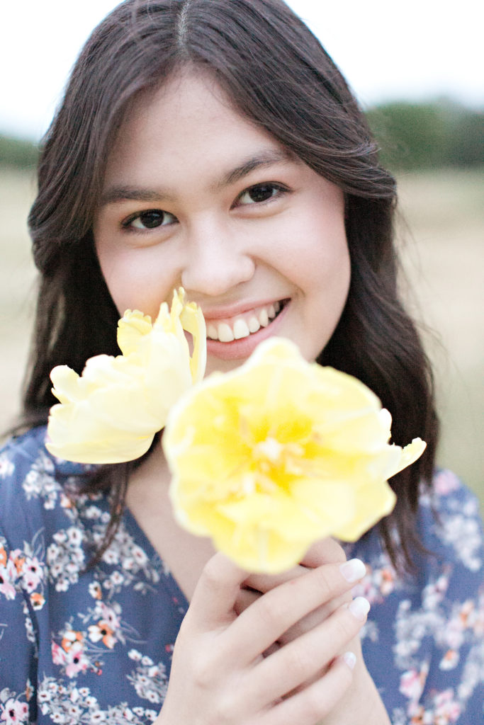 Del Oro senior portraits of teen holding yellow flowers