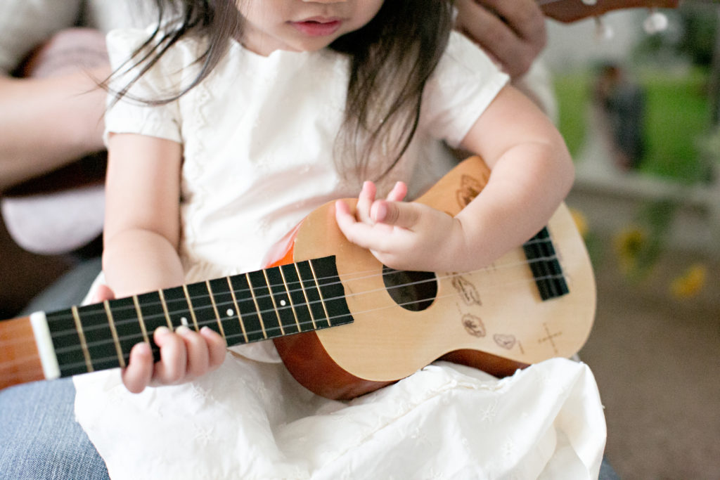Little girl playing ukelele for Sacramento lifestyle family portraits