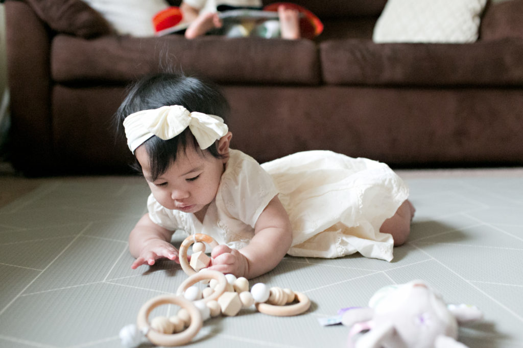Baby playing with toys at Sacramento lifestyle family portraits