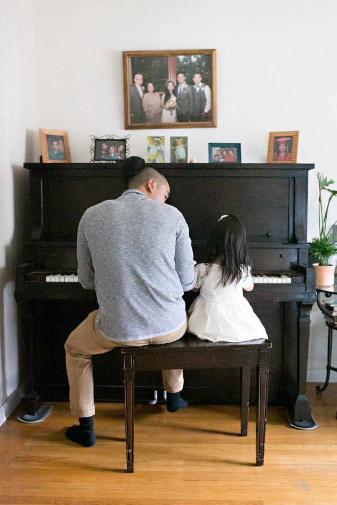 Uncle and niece playing piano Sacramento lifestyle family portraits