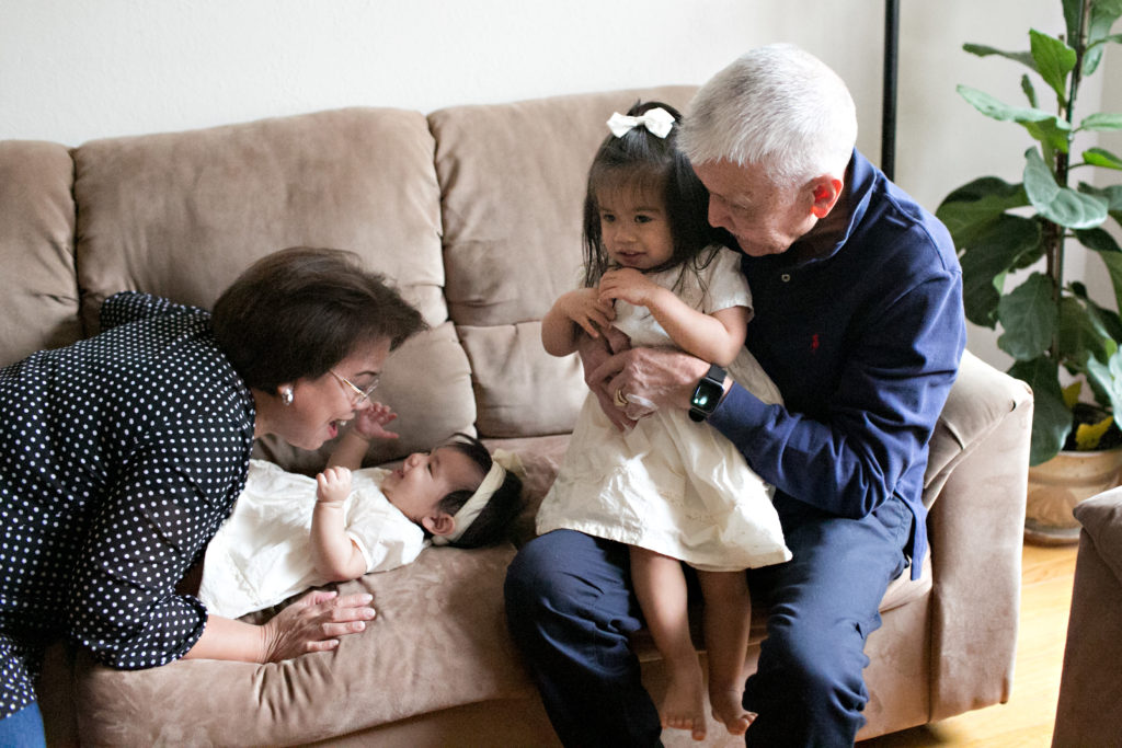Grandparents hugging granddaughters in Sacramento lifestyle family portraits