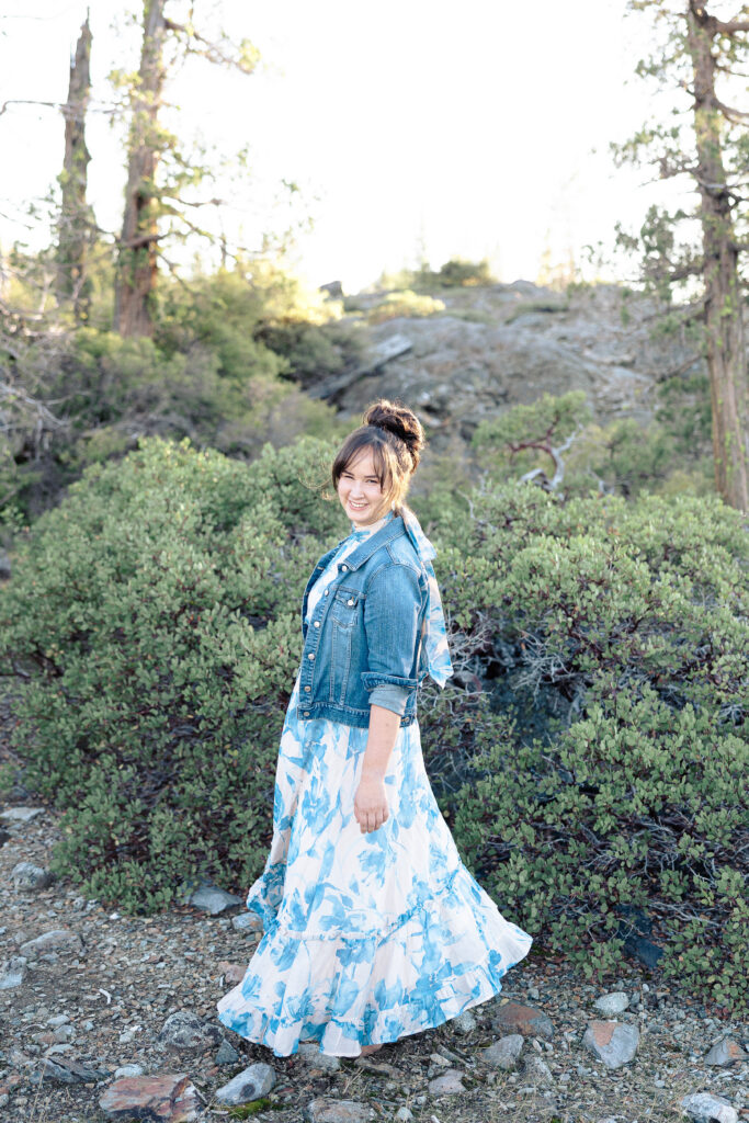 Teen girl smiling and twirling at Nevada City senior portrait session.