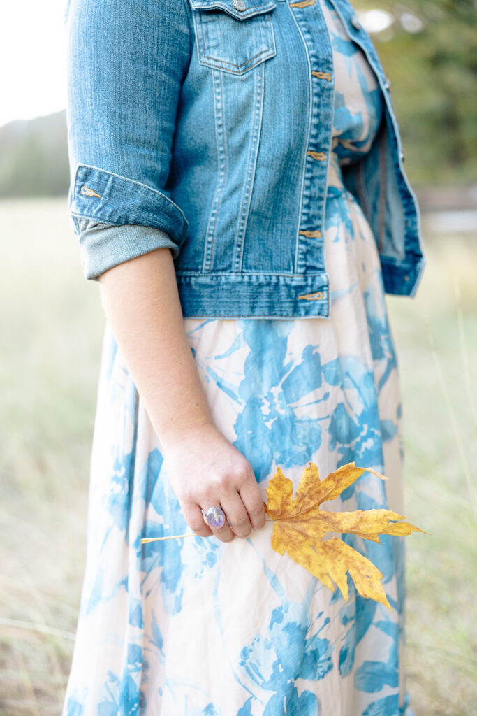 Close up of teen girl holding leaf at Nevada City senior portrait session.