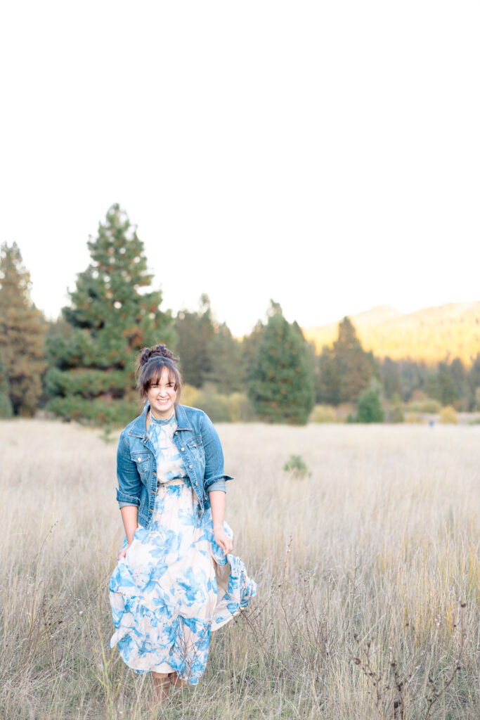 Teen girl walking in meadow at Nevada City senior portrait session.