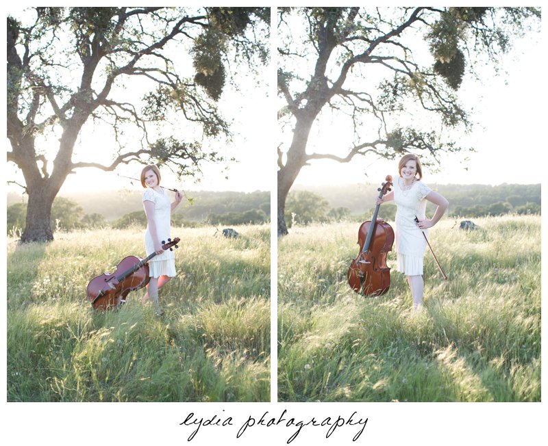 Holding a cello infront of a tree in a field for lifestyle senior portraits in Smartsville, California