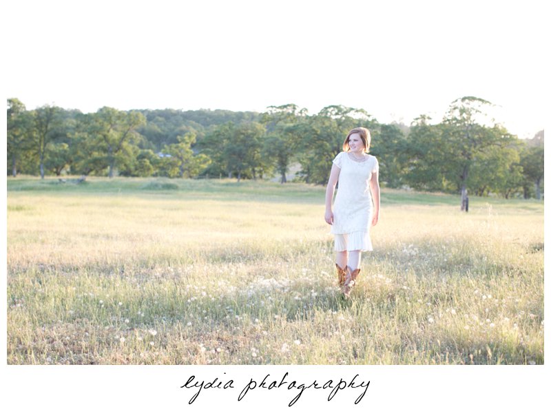 Walking in a field for lifestyle senior portraits in Smartsville, California