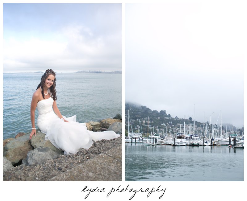 Bride sitting along the shoreline at elegant Sausalito, California wedding at The Spinnaker