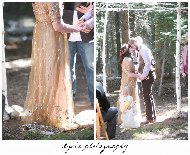 Groom and bride wearing Anthropologie gold dress at intimate rustic vintage woodland wedding in Tahoe, California