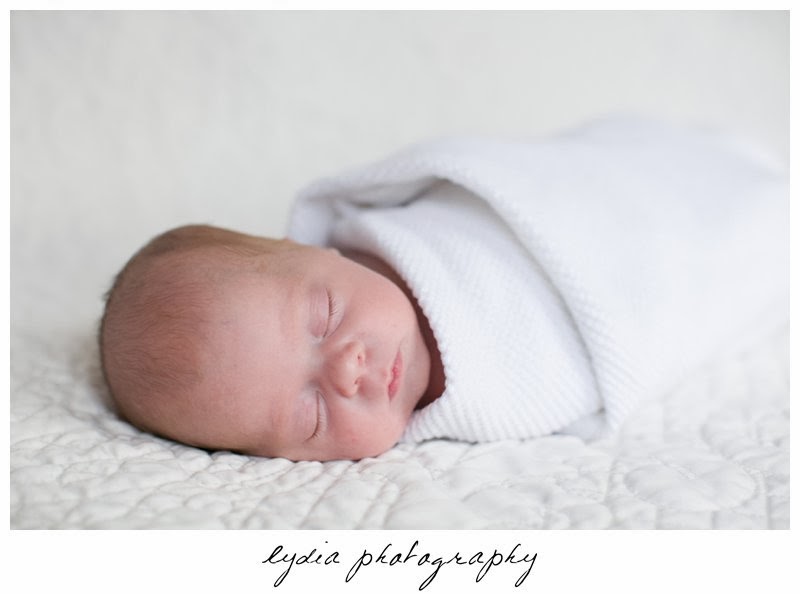 Newborn wrapped in a blanket at newborn portraits in Grass Valley, California