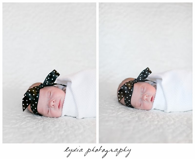 Newborn wrapped in a blanket sleeping with a poke-a-dot headband at newborn portraits in Grass Valley, California