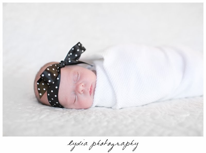 Newborn with a poke-a-dot headband at newborn portraits in Grass Valley, California