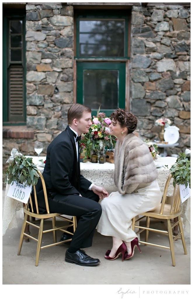 Bride and groom sitting for vintage Downton Abbey wedding at Northstar House in Grass Valley, California