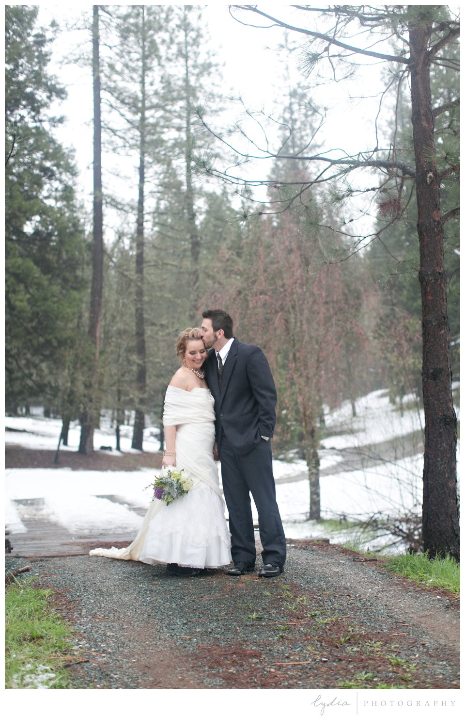 bride and groom standing in the snow in Grass Valley, California
