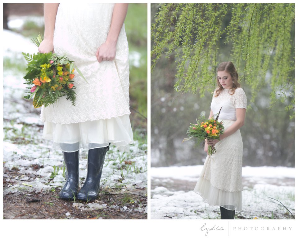 bride holding wedding bouquet and wearing hunter rubber boots in the snow