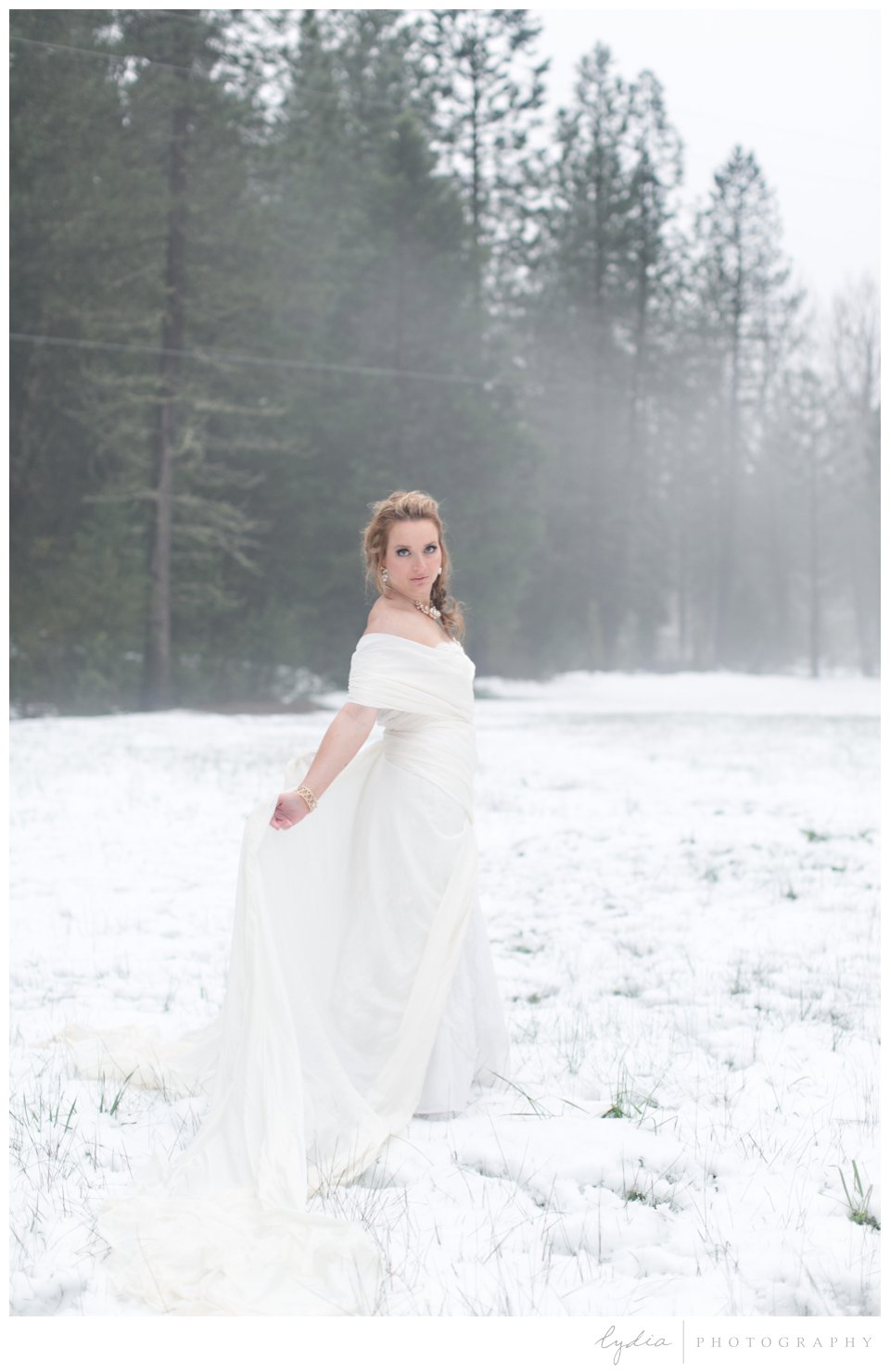 bride in the snow posing like Elsa from frozen 