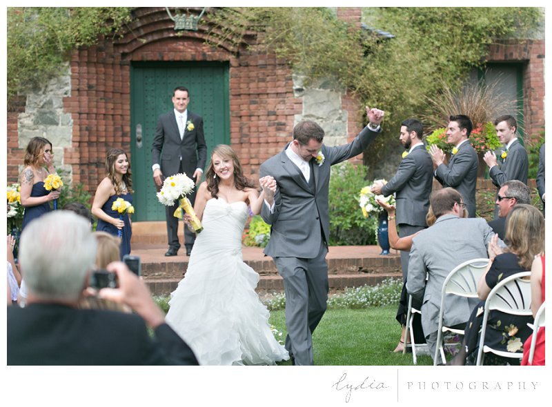 Bride and groom walking down the aisle at elegant vintage Empire Mine wedding in Grass Valley, California
