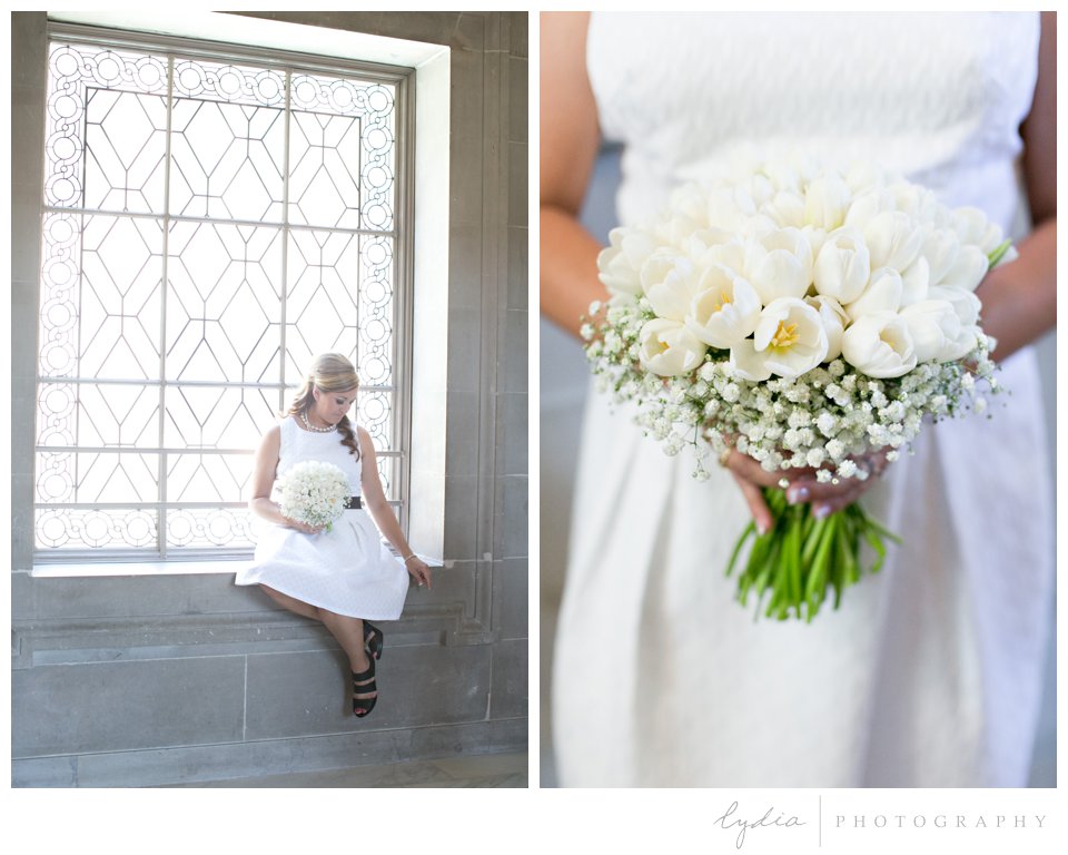 Bride on the window with bouquet at black and white City Hall wedding in San Francisco, California