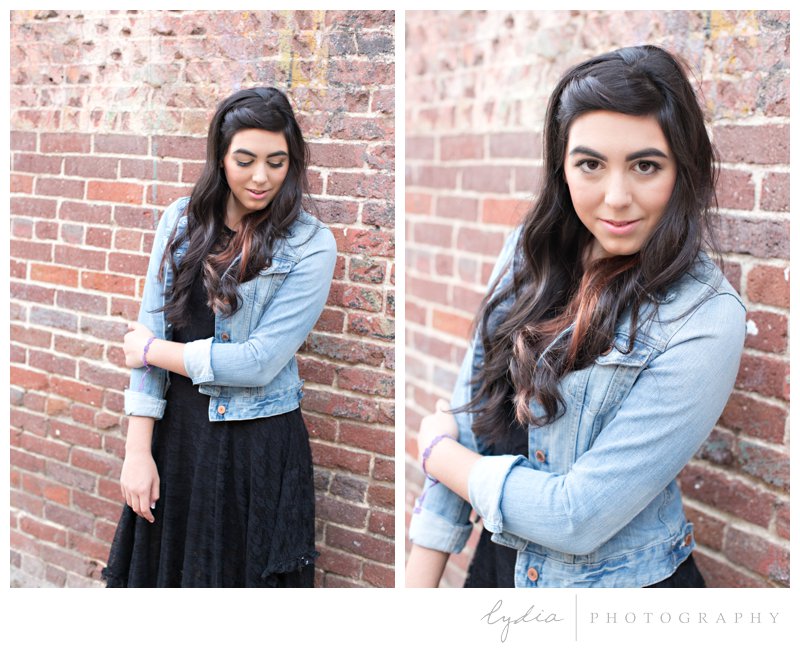 Senior girl infront of a brick wall for lifestyle senior portraits at Nevada City