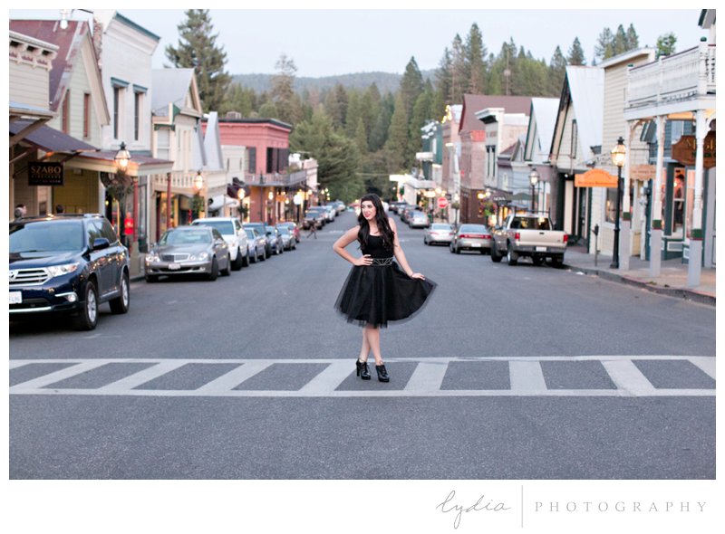 Senior girl in a tulle skirt in the middle of the street for lifestyle senior portraits at Nevada City