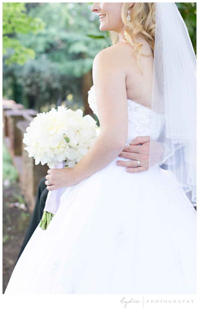 Bride with dahlia bouquet and a ring at Empire Mine fairytale wedding in Grass Valley, California 