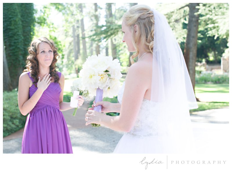 Bridesmaid in a purple dress with bride in her Cinderella Alfred Angelo gown at Empire Mine fairytale wedding in Grass Valley, California 