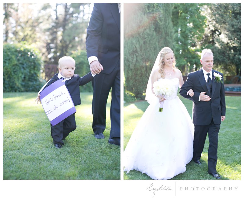 Ringbearer holding a sign and bride with her father at Empire Mine fairytale wedding in Grass Valley, California 