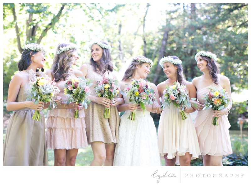 Bride and bridesmaids with bouquets at a garden wedding at Schrammsberg Estate in Grass Valley, California