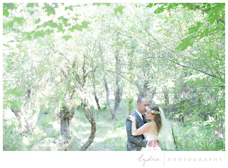 Bride and groom in the woods at a garden wedding at Schrammsberg Estate in Grass Valley, California