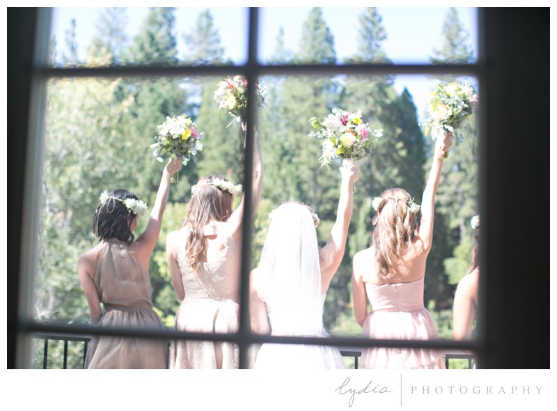 Bride and bridesmaids with bouquets in hand at a garden wedding at Schrammsberg Estate in Grass Valley, California