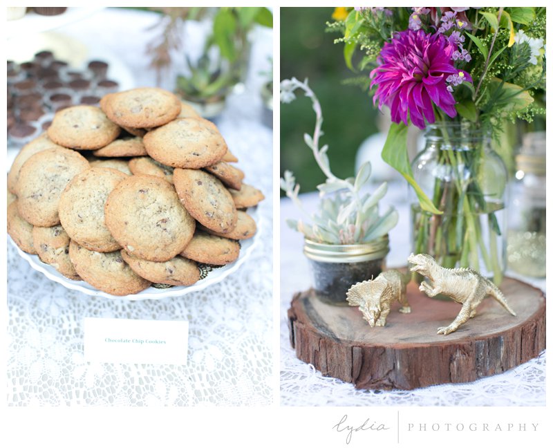 Cookies, gold dinosaurs, and floral table decor at a garden wedding at Schrammsberg Estate in Grass Valley, California