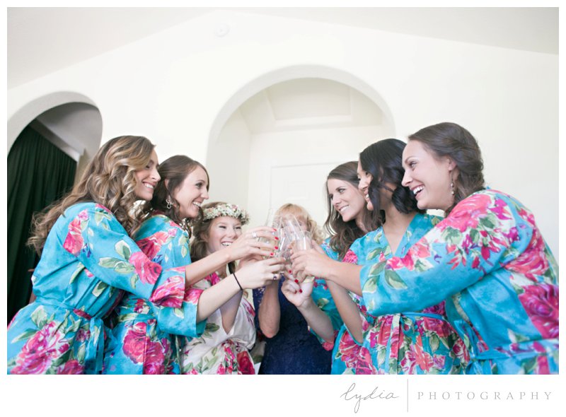 Bride and bridesmaids with matching robes with floral crowns at a garden wedding at Schrammsberg Estate in Grass Valley, California