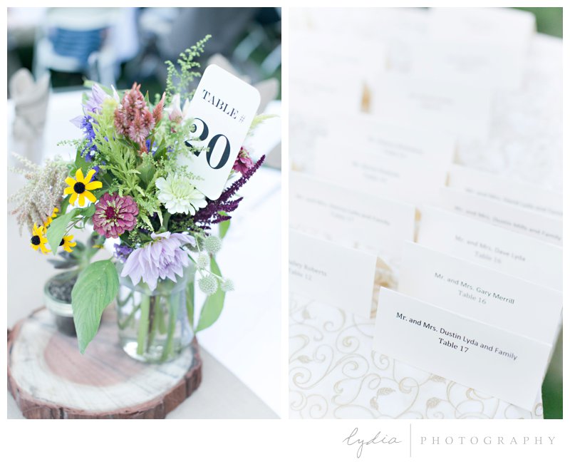 Flowers and table seating cards at a garden wedding at Schrammsberg Estate in Grass Valley, California